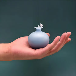 Vela perfumada con jarrón de granada